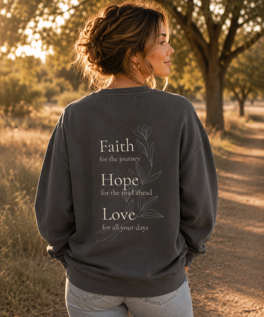 Faith Hope Love Comfort Colors pepper crewneck sweatshirt back view worn outdoors with inspirational floral Christian design