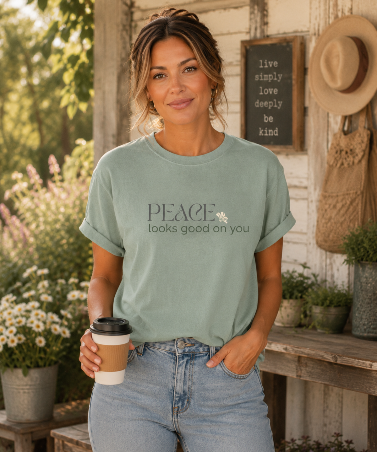 Woman wearing a Bay Comfort Colors graphic t-shirt featuring the inspirational message "Peace looks good on you" in vintage floral lettering.