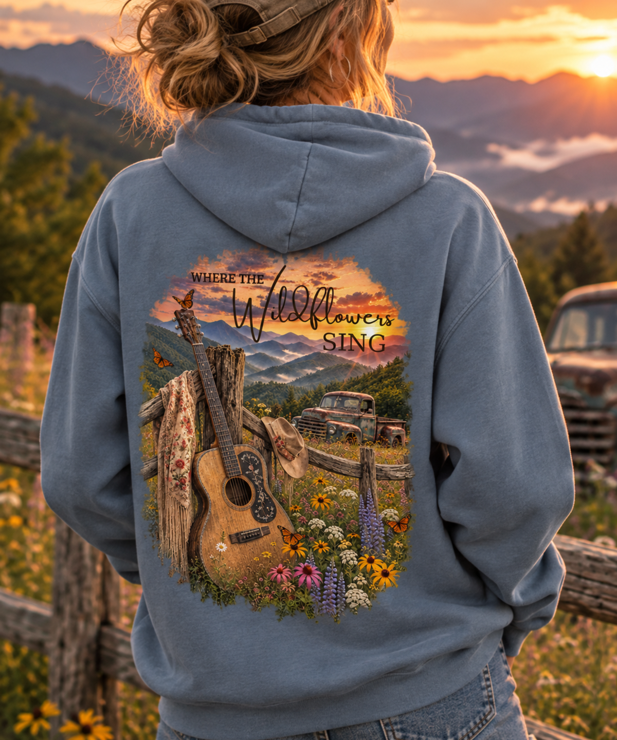 Woman wearing a vintage music hoodie with wildflowers and guitar inspired outdoor graphic