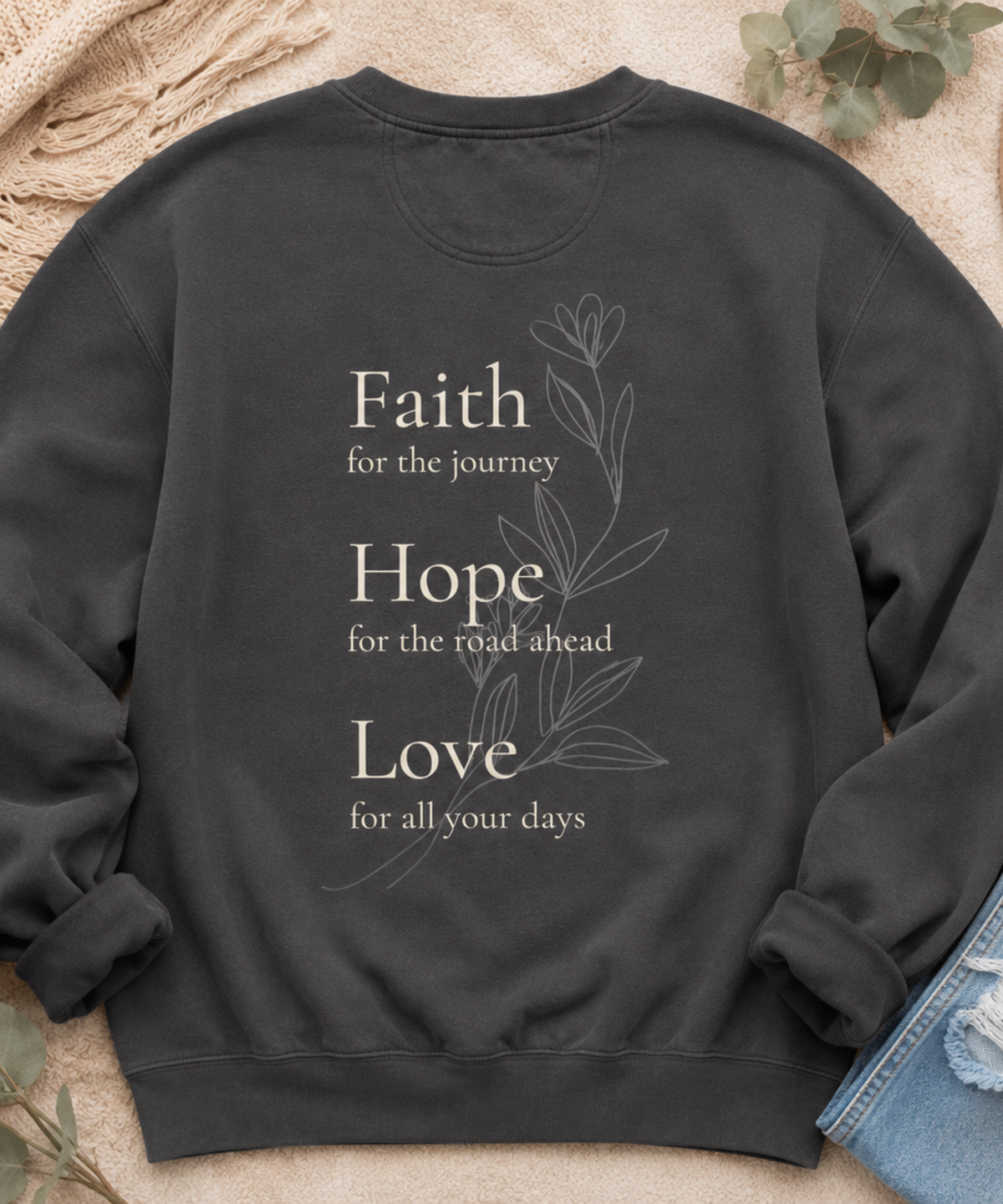 Flat lay of Comfort Colors pepper crewneck sweatshirt featuring Faith Hope Love inspirational floral back print