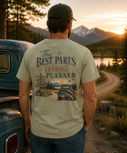 Man wearing The Best Parts Weren’t Planned vintage-inspired road trip T-shirt with large scenic mountain and pickup truck back design.