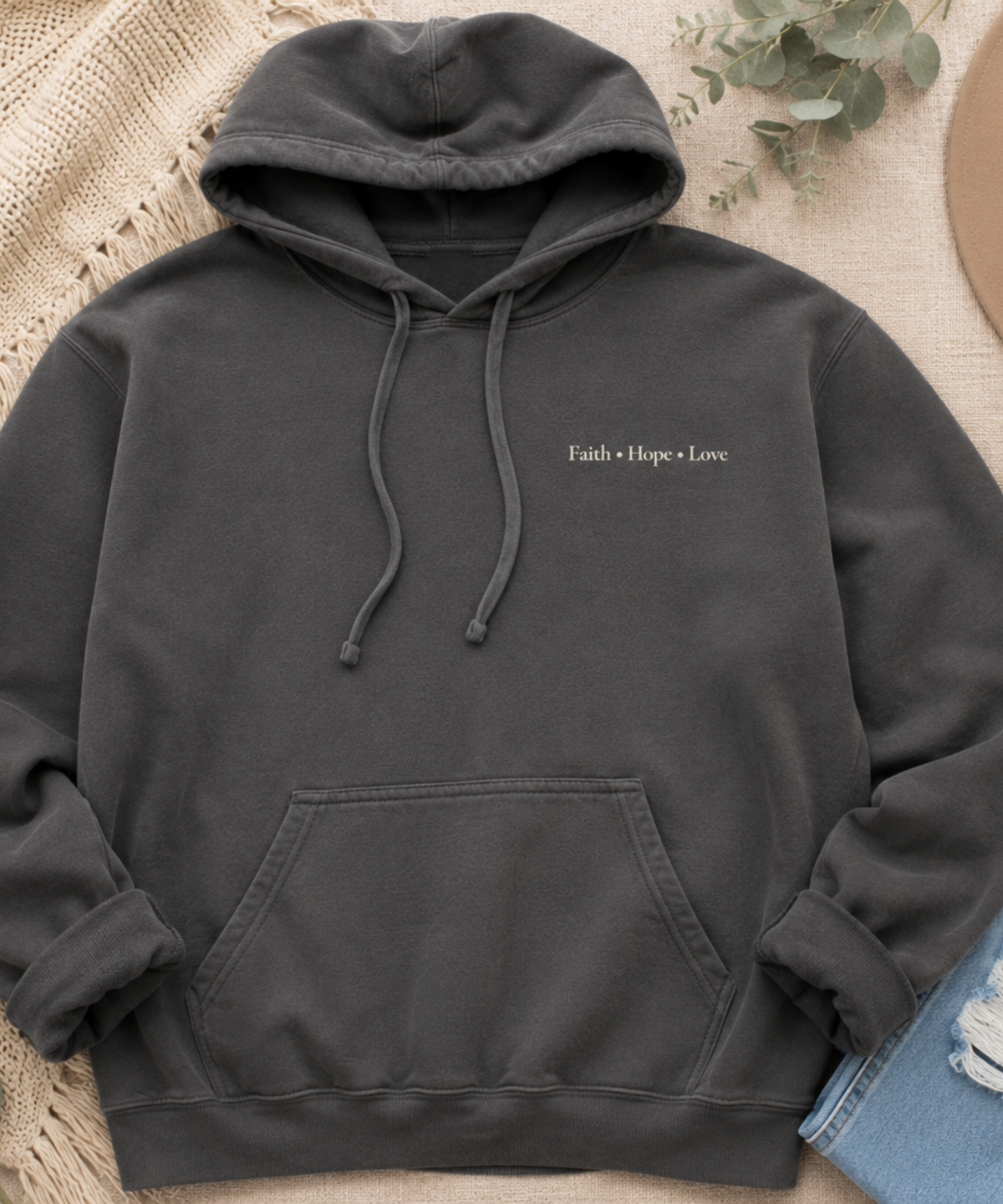 Flat lay of Comfort Colors pepper hoodie with Faith Hope Love left chest inspirational Christian design
