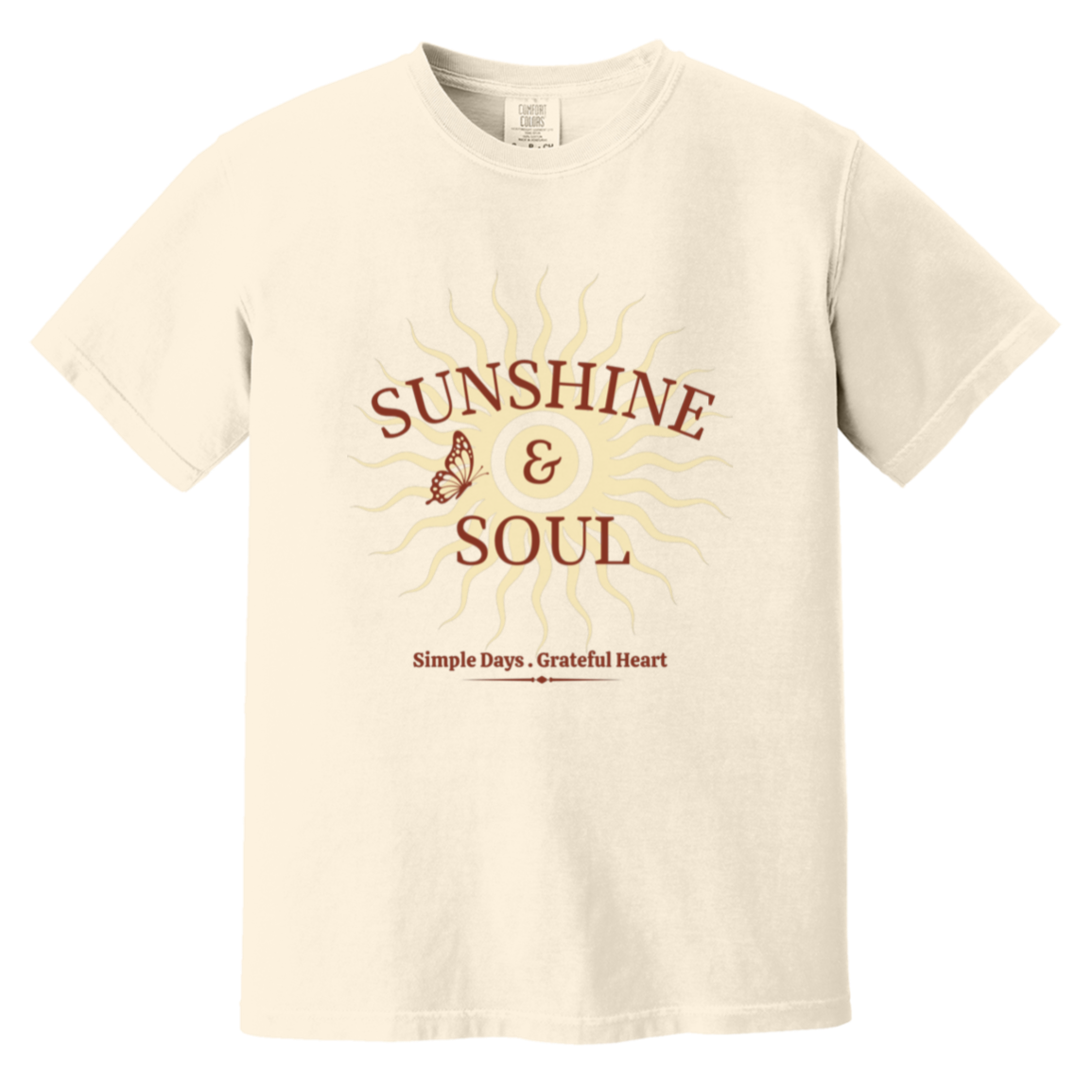 Sunshine & Soul Comfort Colors® ivory t-shirt featuring a vintage sunburst graphic with distressed lettering and the phrase "Simple Days • Grateful Heart" in warm maroon and cream tones.