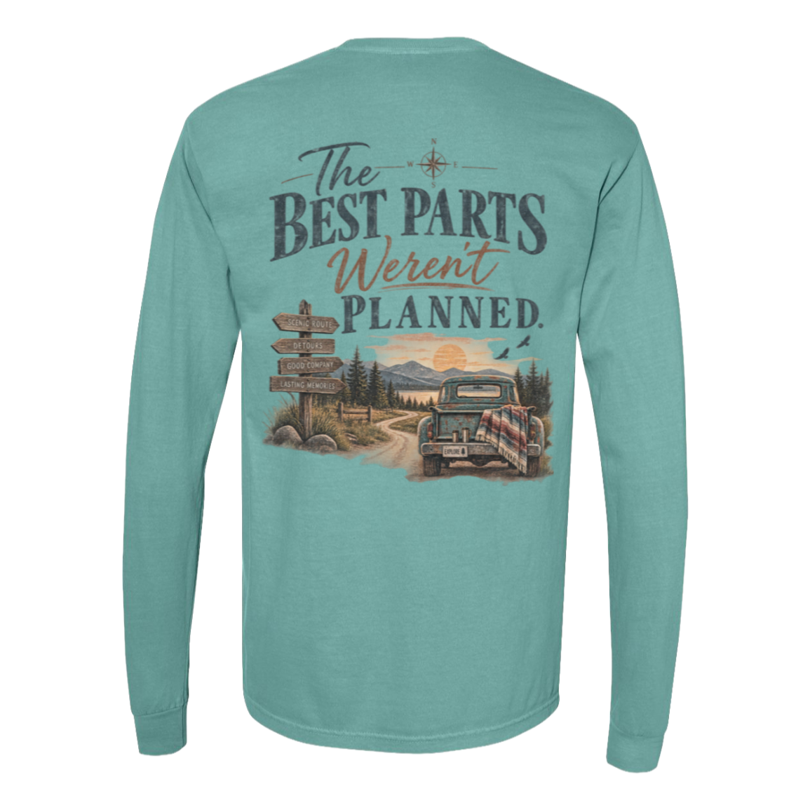 A seafoam green long-sleeve t-shirt shown from the back, featuring a large graphic print with the text 'The BEST PARTS Weren't PLANNED.' above an illustration of a vintage pickup truck on a dirt road with mountains and a sunset.