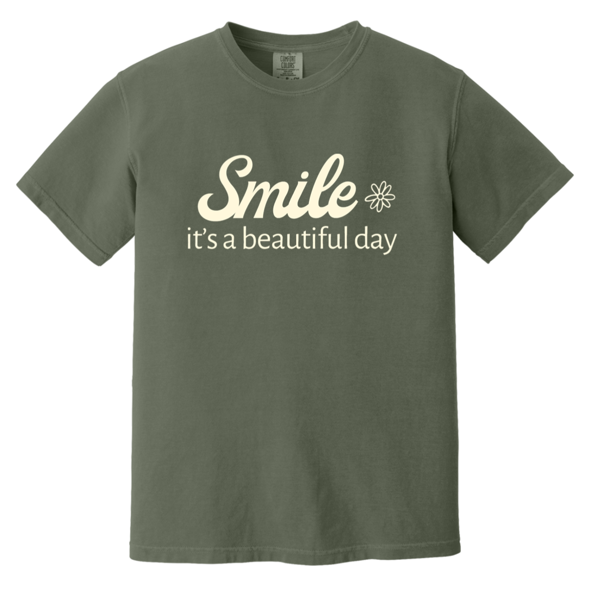 Sage Comfort Colors T-shirt featuring the cream words “Smile, it’s a beautiful day” with a small flower.