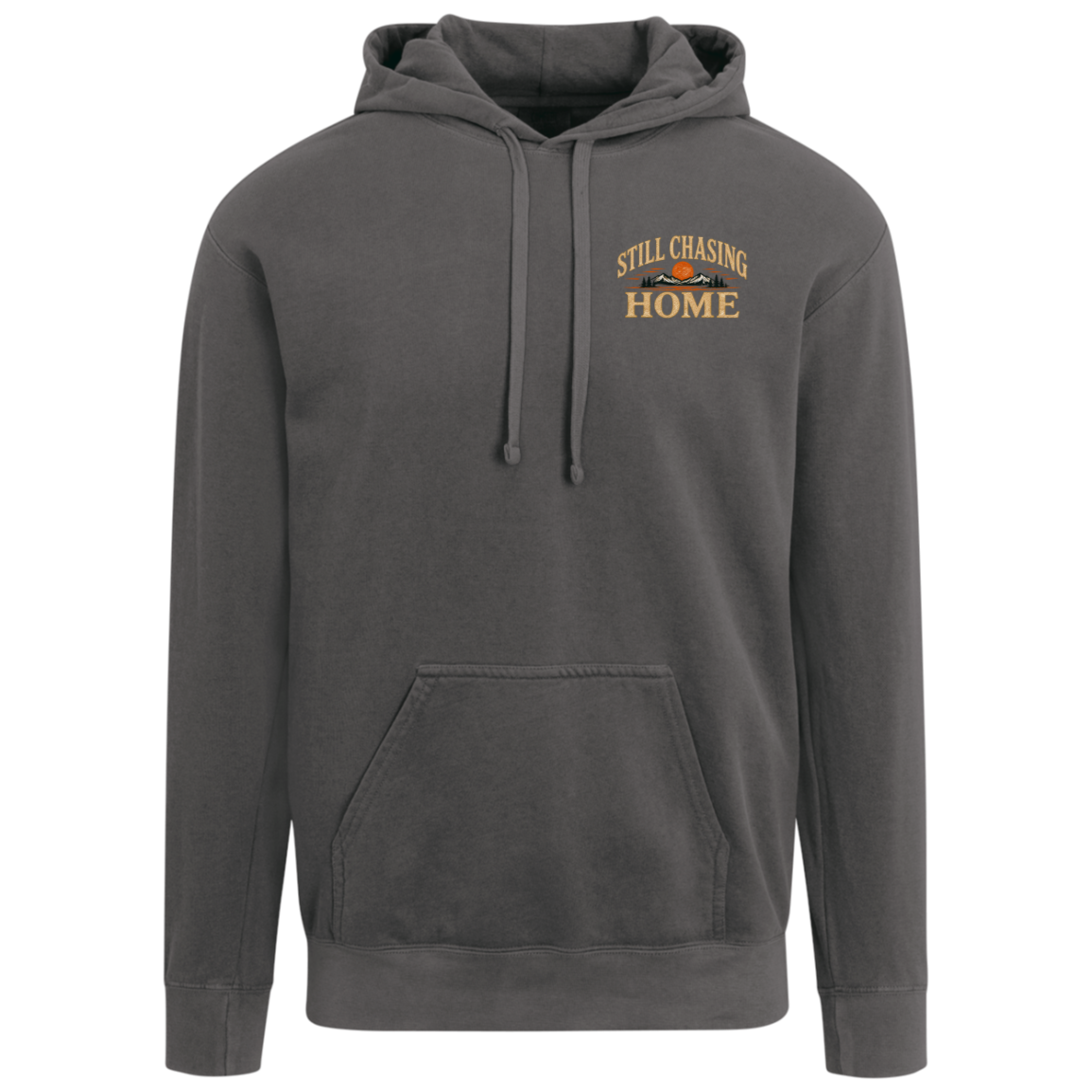 A pepper comfort colors pullover hoodie with a drawstring hood and kangaroo pocket, featuring a small graphic on the left chest that reads 'STILL CHASING HOME' in gold and orange with a mountain silhouette. Includes full back design.