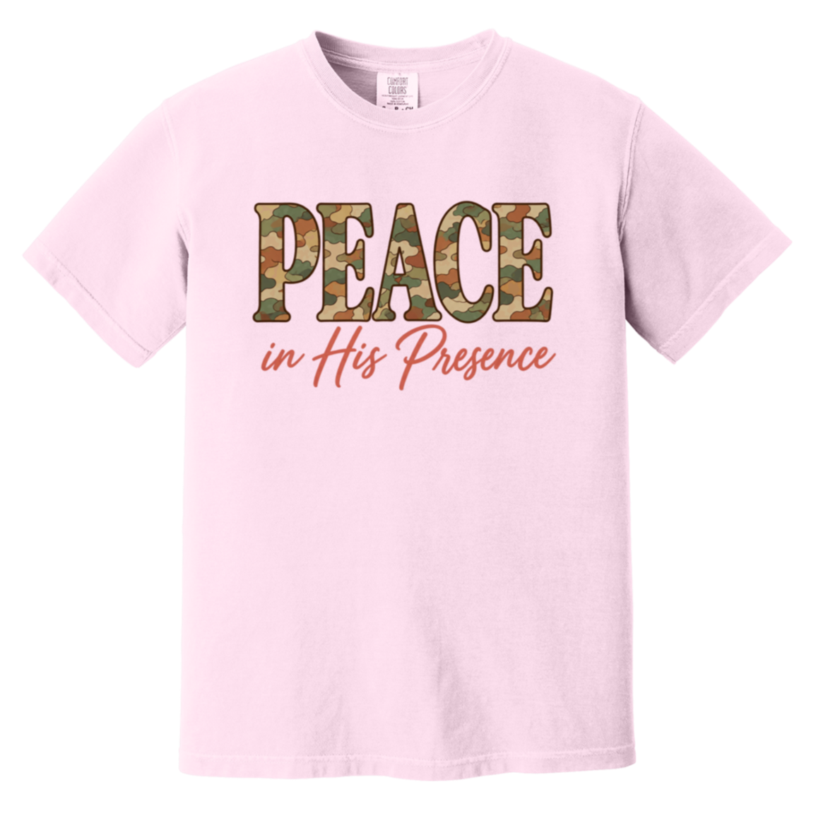A light pink short-sleeve t-shirt featuring a graphic on the chest that reads 'PEACE in His Presence'. The word 'PEACE' is filled with a green, brown, and tan camouflage pattern, while 'in His Presence' is written below in a coral pink cursive font.
