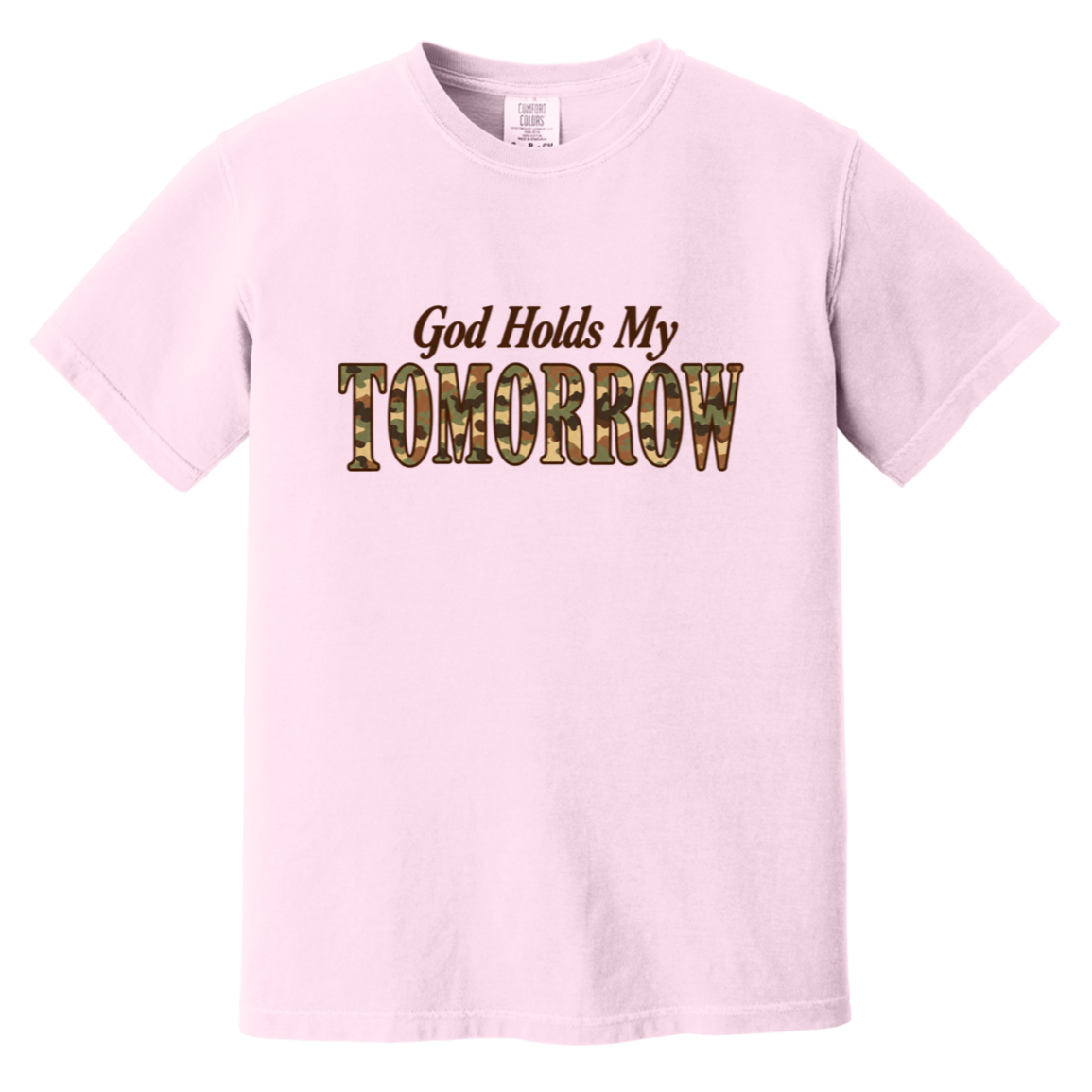 A blossom pink short-sleeve comfort colors t-shirt with a graphic on the chest that reads 'God Holds My TOMORROW' in brown and camouflage lettering, displayed on a solid white background.