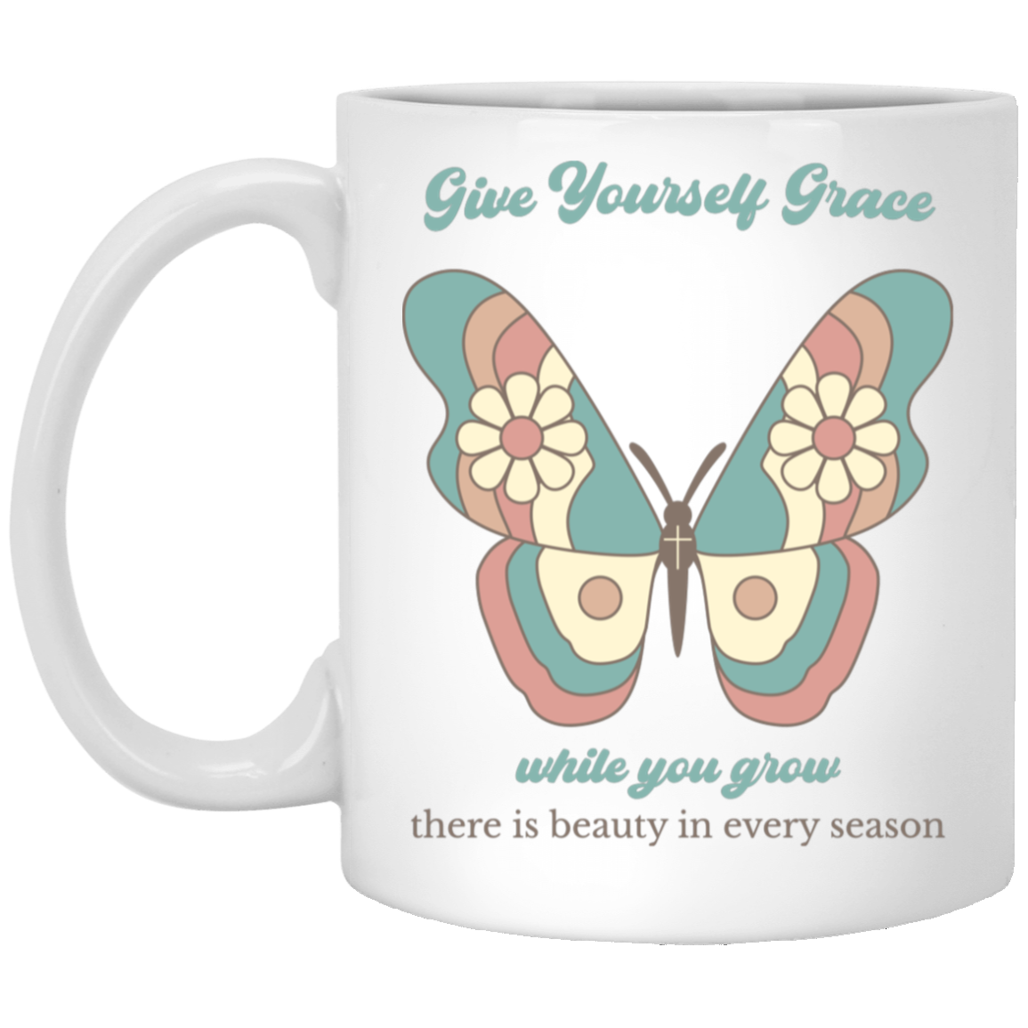 A white ceramic mug featuring a retro-style butterfly graphic with pastel teal, pink, and cream colors, accompanied by the text 'Give Yourself Grace while you grow there is beauty in every season'.