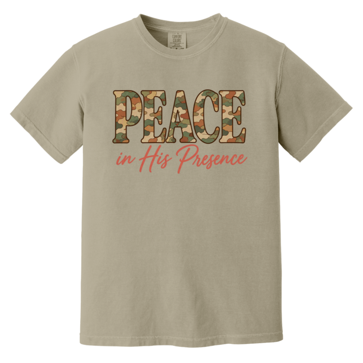 A sandstone comfort colors t-shirt featuring the word 'PEACE' in a camouflage pattern and the phrase 'in His Presence' in coral pink script below it, displayed on a clean white background.