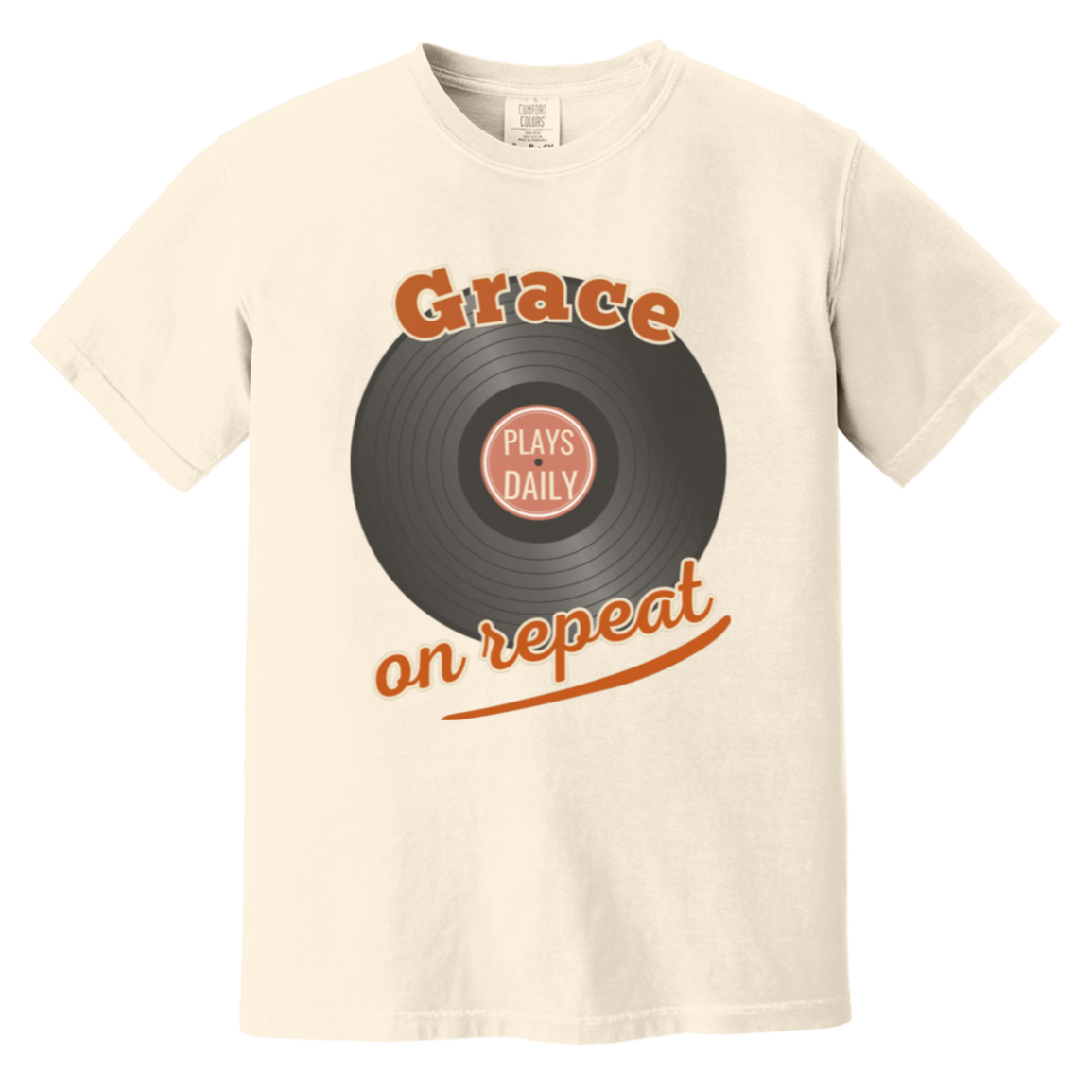 An ivory comfort colors short-sleeve crewneck t-shirt featuring a graphic of a vinyl record with the text 'Grace on repeat' in orange and 'PLAYS DAILY' in the center label.