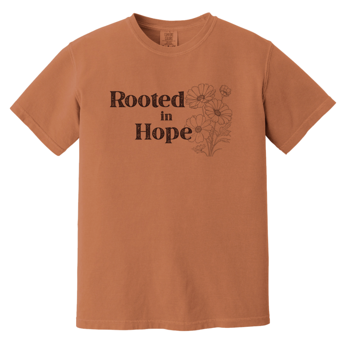 Vintage-inspired Comfort Colors Yam colored t-shirt featuring the phrase “Rooted in Hope” with soft botanical artwork in earthy muted tones.