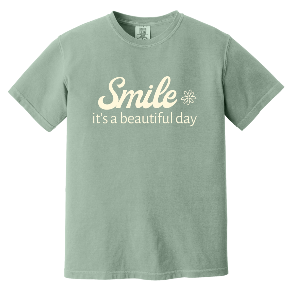 Bay Comfort Colors T-shirt featuring the cream words “Smile, it’s a beautiful day” with a small flower.