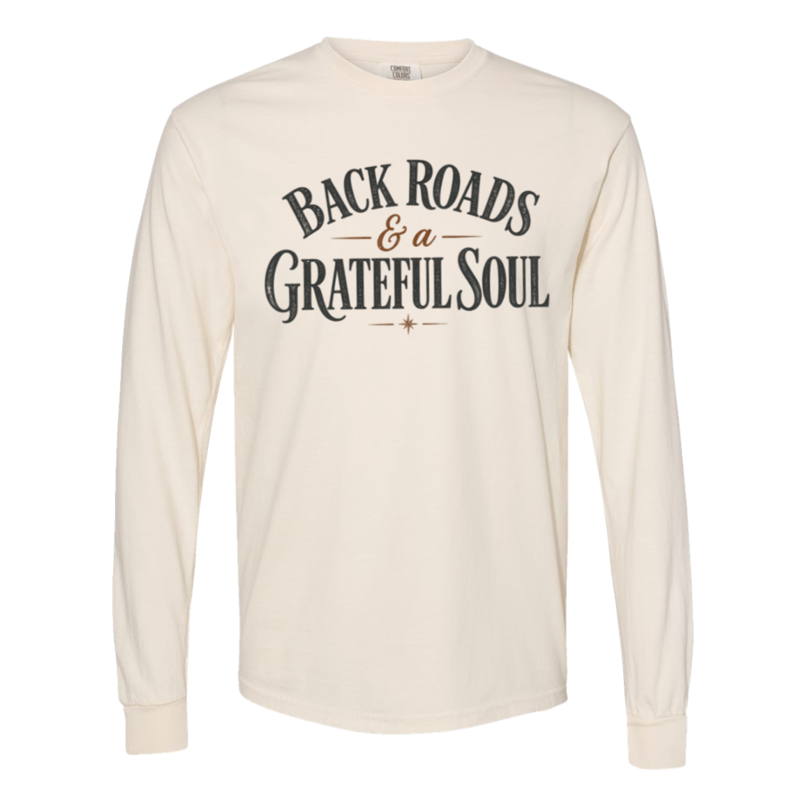 An Ivory comfort colors long-sleeve t-shirt with a distressed graphic on the chest reading 'BACKROADS & A GRATEFUL SOUL' in dark gray and brown.