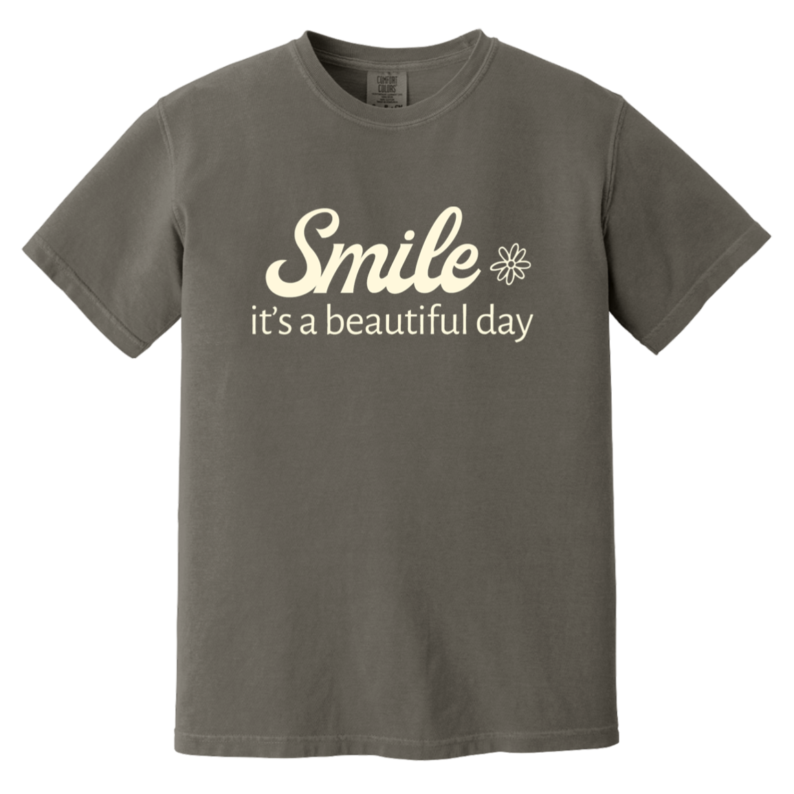 Pepper Comfort Colors T-shirt featuring the cream words “Smile, it’s a beautiful day” with a small flower.