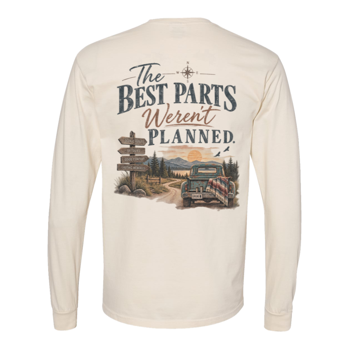 An Ivory colored long-sleeve t-shirt shown from the back, featuring a large graphic print with the text 'The BEST PARTS Weren't PLANNED.' and an illustration of a vintage car on a dirt road.