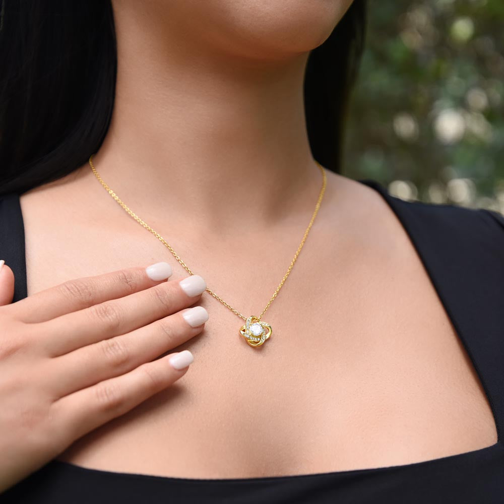 Woman wearing Love Knot necklace meaningful gift from dad to daughter