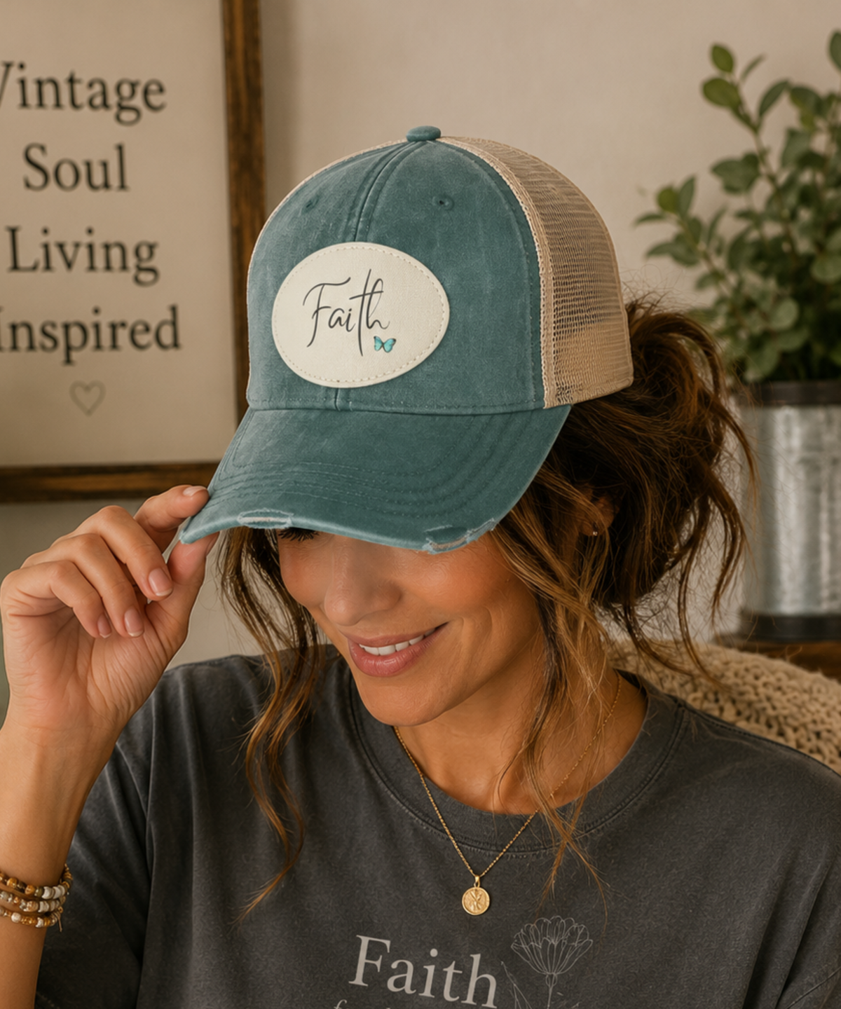 Woman wearing a forest vintage distressed trucker cap featuring an original Faith sublimated vegan leather patch in a cozy rustic home setting.
