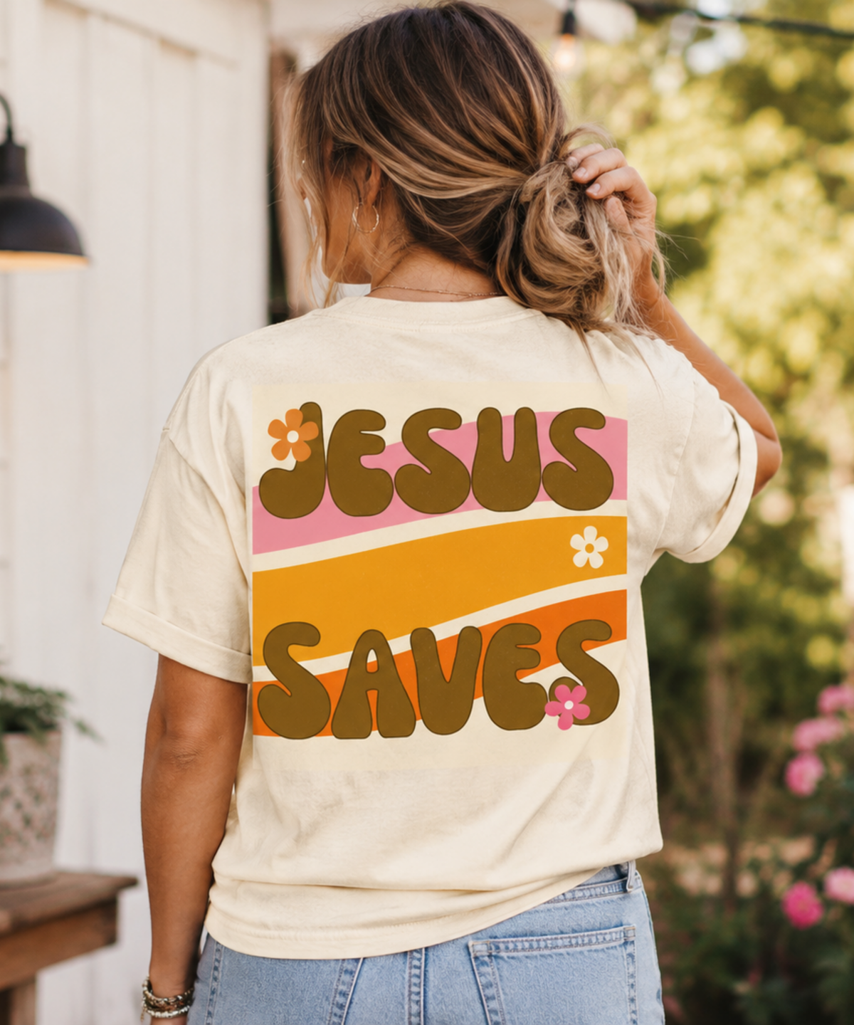 Woman wearing a retro Jesus Saves Comfort Colors t-shirt featuring vintage-inspired typography, warm 70s colors, and faith-filled style.