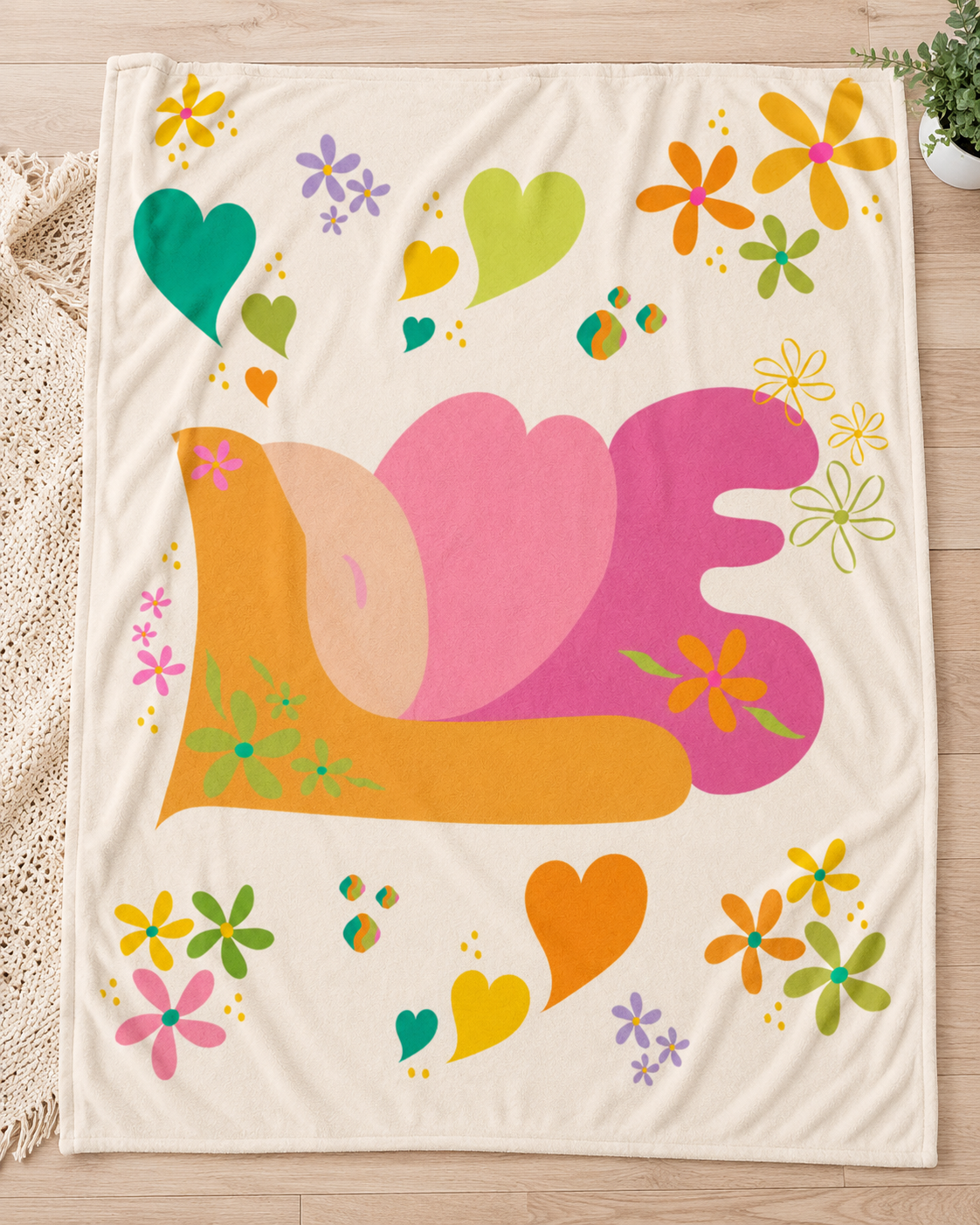 Retro LOVE plush fleece blanket flat lay with colorful floral accents, hearts, and vintage 70s-inspired design on a cream background for cozy home decor.
