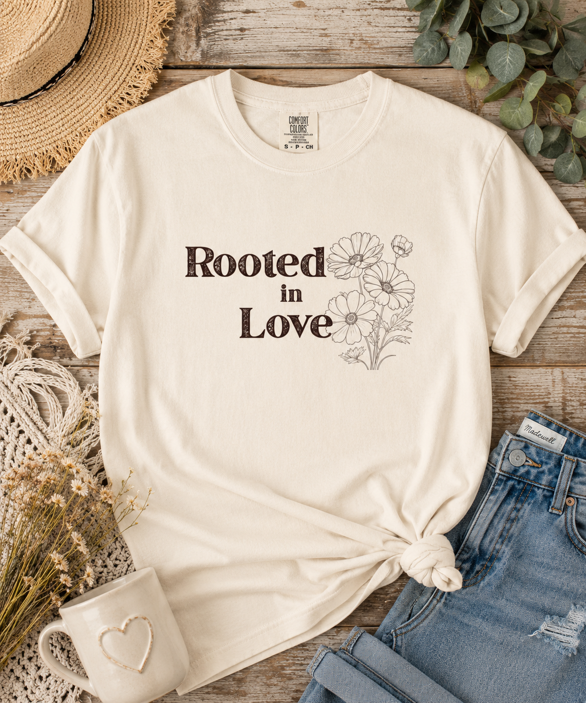 Rooted in Love Comfort Colors graphic tee with vintage floral illustration displayed in a styled flat lay.